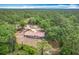 Beautiful aerial shot of a secluded home surrounded by dense forest and a long winding drive at 4931 Tropicana Dr, Indian Lake Estates, FL 33855