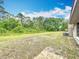 Spacious backyard offers potential for outdoor activities and features lush trees and a large grass area at 4931 Tropicana Dr, Indian Lake Estates, FL 33855
