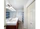 Bathroom features dual sinks, wood cabinets, and sleek fixtures at 4931 Tropicana Dr, Indian Lake Estates, FL 33855