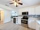 Modern kitchen featuring stainless steel appliances, updated lighting, and beautiful countertops at 4931 Tropicana Dr, Indian Lake Estates, FL 33855