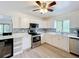Bright kitchen features stainless steel appliances, white cabinetry, and a stylish countertop at 4931 Tropicana Dr, Indian Lake Estates, FL 33855