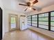 Sunny kitchen features tile floors, an exterior door and great natural light at 4931 Tropicana Dr, Indian Lake Estates, FL 33855