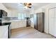 Modern kitchen features stainless appliances, and white cabinetry at 4931 Tropicana Dr, Indian Lake Estates, FL 33855