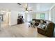 Spacious living room boasts abundant natural light and laminate floors at 4931 Tropicana Dr, Indian Lake Estates, FL 33855