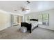 Spacious main bedroom with sliding door access to sunroom and a ceiling fan at 4931 Tropicana Dr, Indian Lake Estates, FL 33855