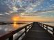 Picturesque shot of a pier stretching into the water at sunset with a cloudy sky at 4931 Tropicana Dr, Indian Lake Estates, FL 33855