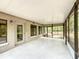 Spacious screened-in porch offering an inviting and serene outdoor living space with natural light at 4931 Tropicana Dr, Indian Lake Estates, FL 33855