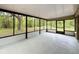 Large screened-in porch providing a tranquil space with views of the surrounding lush greenery and trees at 4931 Tropicana Dr, Indian Lake Estates, FL 33855