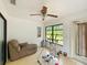 Bright sunroom featuring tile floors, a ceiling fan, a lounge chair, and an exercise machine at 4931 Tropicana Dr, Indian Lake Estates, FL 33855