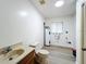 Utility room with a toilet, sink, water heater, and neutral paint at 4931 Tropicana Dr, Indian Lake Estates, FL 33855