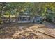 Secluded backyard with mature trees providing ample shade, complemented by a partial fence at 700 Crestwood Way, Winter Springs, FL 32708