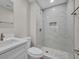 Modern bathroom featuring a walk-in shower with tile surround, floating vanity, and updated fixtures at 700 Crestwood Way, Winter Springs, FL 32708