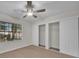 Bedroom with wood-look floors, a ceiling fan, lots of natural light, and a closet with sliding doors at 700 Crestwood Way, Winter Springs, FL 32708