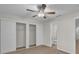 Bedroom with a ceiling fan, closet with sliding doors, and access to an ensuite bathroom at 700 Crestwood Way, Winter Springs, FL 32708