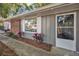 Charming home exterior showcasing a brick accent, well-maintained garden, and white-framed windows at 700 Crestwood Way, Winter Springs, FL 32708