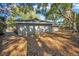 Rear exterior of a well-kept single-story home featuring a roofline and fenced backyard at 700 Crestwood Way, Winter Springs, FL 32708