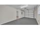 Spacious two-car garage with a clean painted floor and an automatic door opener system at 700 Crestwood Way, Winter Springs, FL 32708