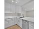 Bright kitchen featuring stainless steel appliances, white cabinets, stone countertops, and a stainless steel sink at 700 Crestwood Way, Winter Springs, FL 32708