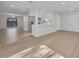 Spacious living area featuring wood flooring, a breakfast bar, a stainless steel refrigerator, and lots of natural light at 700 Crestwood Way, Winter Springs, FL 32708