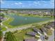 Aerial view of a residential community featuring a lake, golf course, and well-maintained roadways at 8534 Sw 59Th Lane Rd, Ocala, FL 34481