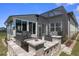 Spacious backyard with a built-in grill area, screened lanai, and views of the neighboring houses at 8534 Sw 59Th Lane Rd, Ocala, FL 34481