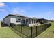 Large, fully-fenced backyard featuring both screened and glassed-in lanais, and an outdoor kitchen at 8534 Sw 59Th Lane Rd, Ocala, FL 34481