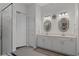 Spacious bathroom with double vanity, stylish mirrors, and glass shower enclosure at 8534 Sw 59Th Lane Rd, Ocala, FL 34481