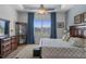 Bright bedroom features large window, tray ceiling, and classic wood furniture at 8534 Sw 59Th Lane Rd, Ocala, FL 34481