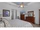 This bedroom has a ceiling fan, wood floors and a furniture set at 8534 Sw 59Th Lane Rd, Ocala, FL 34481