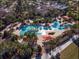 Aerial shot of a resort-style pool with cabanas surrounded by beautiful trees at 8534 Sw 59Th Lane Rd, Ocala, FL 34481
