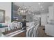 Open dining room connected to living room and kitchen, with six chairs and wooden chandelier at 8534 Sw 59Th Lane Rd, Ocala, FL 34481