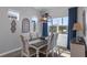 Well-lit dining room has large windows with seating for six and stylish chandelier lighting at 8534 Sw 59Th Lane Rd, Ocala, FL 34481