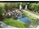 Landscaped community entrance featuring a waterfall and decorative towers along the roadway at 8534 Sw 59Th Lane Rd, Ocala, FL 34481