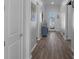 Bright hallway with wood floors leads to a decorative glass front door and complements the modern design at 8534 Sw 59Th Lane Rd, Ocala, FL 34481