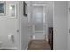 Bright hallway with wood floors leading to the laundry room and other areas of the home at 8534 Sw 59Th Lane Rd, Ocala, FL 34481