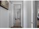 Hallway features wood and tile flooring, with white trim and doors at 8534 Sw 59Th Lane Rd, Ocala, FL 34481