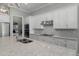 Bright kitchen showcases white cabinets, quartz counters, stainless steel appliances, and a decorative backsplash at 8534 Sw 59Th Lane Rd, Ocala, FL 34481