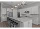 Modern kitchen featuring an island with seating, stainless steel appliances, and tiled backsplash at 8534 Sw 59Th Lane Rd, Ocala, FL 34481