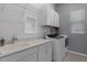 Well-organized laundry room featuring modern appliances, ample counter space, and plenty of cabinet storage at 8534 Sw 59Th Lane Rd, Ocala, FL 34481