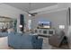 Relaxing living room features tray ceilings, fan, plush furniture, television and sliding glass doors to lanai at 8534 Sw 59Th Lane Rd, Ocala, FL 34481