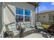 Comfortable screened patio with stylish wicker furniture, perfect for outdoor relaxation and entertaining at 8534 Sw 59Th Lane Rd, Ocala, FL 34481