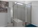 Modern glass enclosed shower features tiled walls and a built-in bench at 8534 Sw 59Th Lane Rd, Ocala, FL 34481