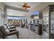 Inviting sunroom filled with natural light, comfortable seating, ceiling fan, and decorative fireplace at 8534 Sw 59Th Lane Rd, Ocala, FL 34481