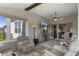 Cozy sunroom features comfortable seating, natural light, ceiling fan, and a view to the outdoors at 8534 Sw 59Th Lane Rd, Ocala, FL 34481