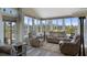 Bright sunroom with comfortable seating, ample natural light, and a view of the backyard at 8534 Sw 59Th Lane Rd, Ocala, FL 34481