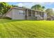 Expansive backyard with lush green lawn and screened-in patio at 248 Lake Tennessee Dr, Auburndale, FL 33823