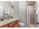 Well-lit bathroom featuring walk-in shower, wooden vanity, and ample counter space at 248 Lake Tennessee Dr, Auburndale, FL 33823