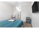 Comfortable bedroom features a flat-screen TV, stylish chair and convenient mini refrigerator at 248 Lake Tennessee Dr, Auburndale, FL 33823