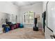 Home exercise room filled with sunlight from a window, exercise equipment, a mirror and a neutral carpet at 248 Lake Tennessee Dr, Auburndale, FL 33823