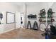 Carpeted home exercise room featuring workout equipment, a desk, shelves, and a window into the next room at 248 Lake Tennessee Dr, Auburndale, FL 33823